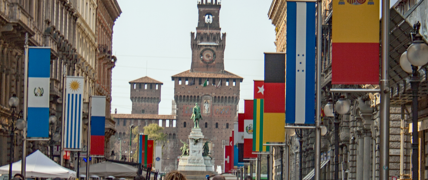Via Dante with Sforza Castle in Milan People walk along Via Dante in the historic center towards Castello Sforzesco in Milan