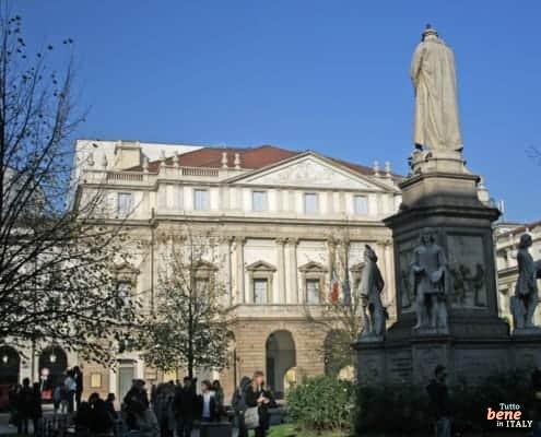 The Leonardo da Vinci monument in Piazza della Scala, Milan, with the facade of Teatro alla Scala in the background.