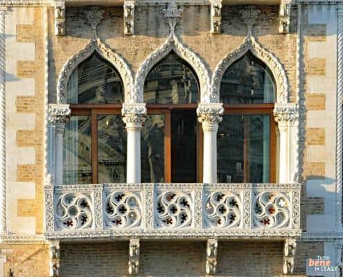 Intricate Gothic balcony and arched windows of the Palazzo Contarini Fasan in Venice featuring exquisite stonework.