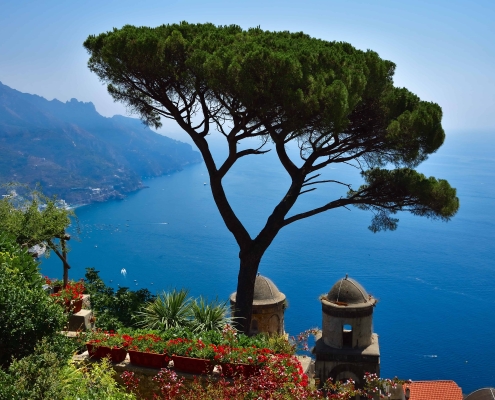 Wahrzeichen von Ravello – Pinie der Villa Rufolo • ©BARBARA BAJOREK - stock.adobe.com Klassischer Ausblick von der Villa Rufolo in Ravello mit der markanten Pinie, historischen Türmen und Blick auf die Amalfiküste.