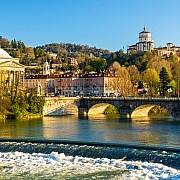 Turin Po River Gran Madre di Dio Monte dei Cappuccini Bridge • Copyright ©Leonid Andronov - stock.adobe.com View across the Po River with a weir towards the Gran Madre di Dio church and the Monte dei Cappuccini convent in Turin under a bright sky.