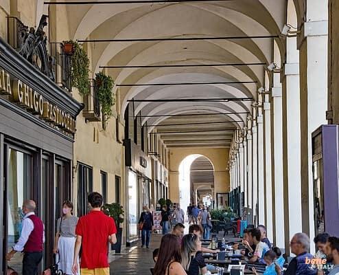 Cremeria Ghigo Turin Arcades Cafe Pastisceria Via Po • m24o Pedestrians walk under the historic arcades of Turin past the outdoor seating of the traditional Cremeria Ghigo cafe.