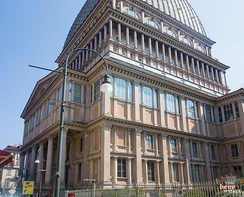 Mole Antonelliana Turin Landmark National Cinema Museum Dome • m24o The monumental Mole Antonelliana in Turin with its distinct high dome and sharp spire against a clear blue sky.
