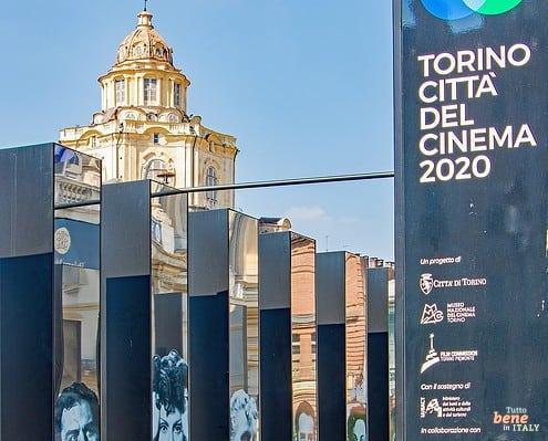 Torino Citta del Cinema Piazza Castello San Lorenzo Turin • m24o Modern cinema exhibition pillars with actor portraits at Piazza Castello in Turin, featuring the baroque dome of San Lorenzo in the background.