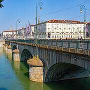 Turin Po River Bridge Ponte Vittorio Emanuele I Mole Antonelliana • m24o View over the green Po River towards the stone bridge Ponte Vittorio Emanuele I in Turin with the Mole Antonelliana in the background.