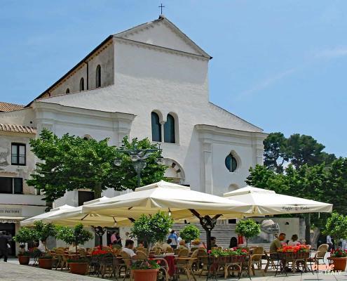 Ravello Cathedral – Historic Heart of Piazza Vescovado • m24o Ravello Cathedral (Duomo di Ravello) at Piazza Vescovado with a cafe and white umbrellas in the foreground.