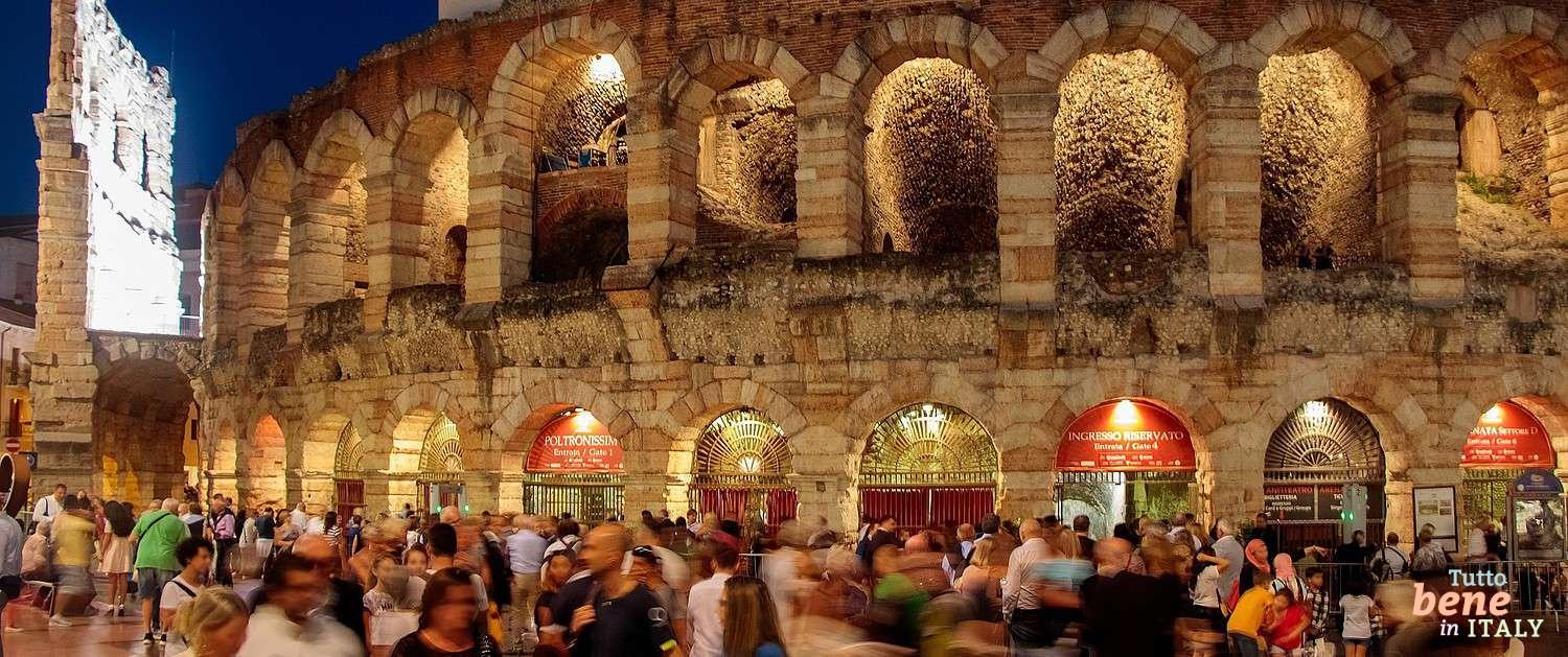 Arena di Verona Opera Festival Evening Mood Atmospheric night shot of the Arena di Verona with visitors at Piazza Brà during the Opera Festival.