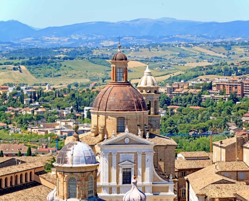 View over Macerata’s Dome into the Marche Countryside • m24o High-angle shot from a tower showing a prominent church dome in Macerata with the rolling hills of the Marche region in the background.