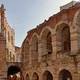 The exterior facade of the Arena di Verona during the day.