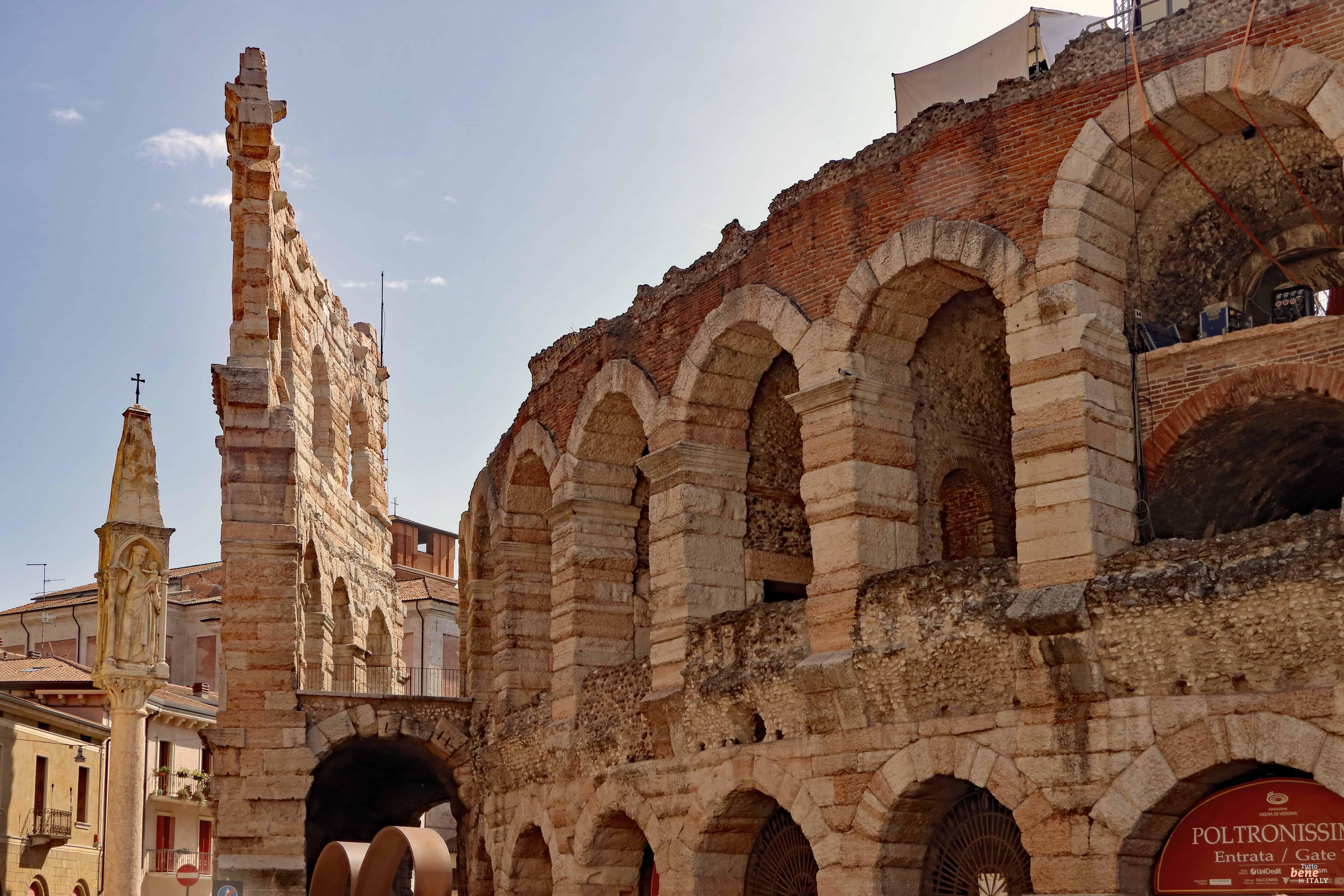 The exterior facade of the Arena di Verona during the day.