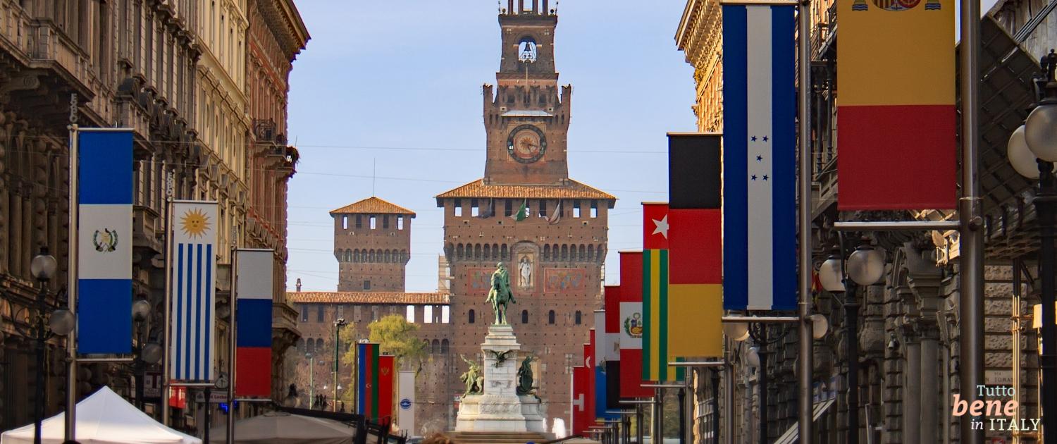 Via Dante with Sforza Castle in Milan People walk along Via Dante in the historic center towards Castello Sforzesco in Milan