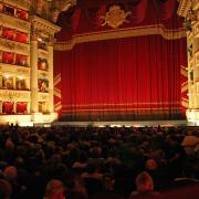 In the occupied auditorium of La Scala, visitors expect the opera performance