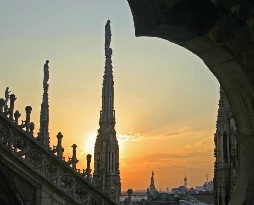 Sunset on the cathedral terraces with a view over the rooftops of Milan