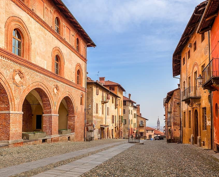 Colorful houses and cobbled street in old town of Saluzzo in Piedmont, Northern Italy.