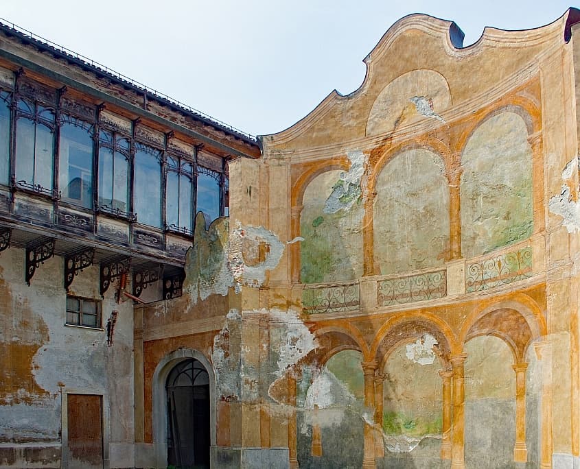 Courtyard of a historic palace with frescoes in Novi Ligure in Piedmont, Italy