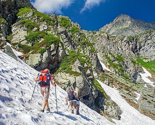 Hiking at the foot of the Monviso, where there is still snow in summer