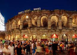 Atmospheric night shot of the Arena di Verona with visitors at Piazza Brà during the Opera Festival.